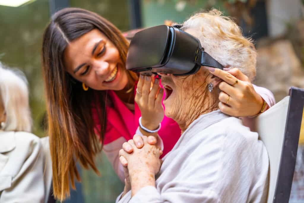 Amazed old woman using virtual reality goggles in a geriatric